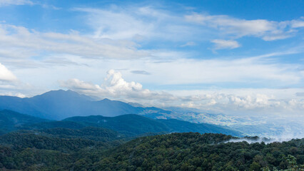 Fototapeta premium Natural view countryside of mountain forest with blue sky background. Nature rainforest landscape.