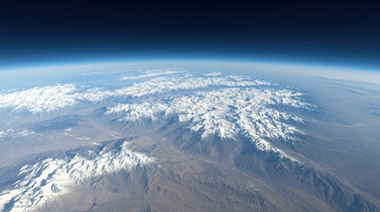 Fototapeta premium Aerial View of Snow-Capped Mountains and Earth Atmosphere