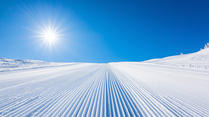 Ski resort concept,perfectly groomed ski slope stretches towards horizon,basked in sunlight beneath a vibrant blue sky,inviting winter sports enthusiasts to enjoy,copy space