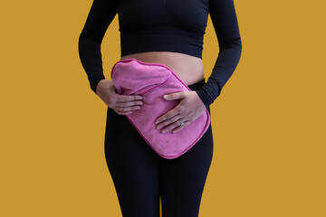 Young female hunched over and holding stomach, perhaps needing to use the bathroom or toilet,...