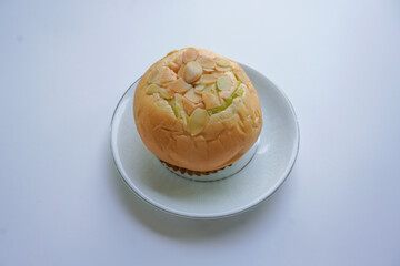 Delicious, soft custard-filled bread on a white plate with a white backdrop.