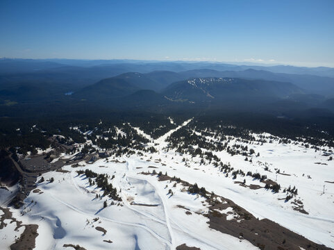 A snowy mountain range with a clear blue sky