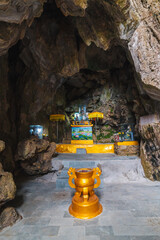 Buddhist temple with statues and sanctuary inside Lynch Nham Cave in the Marble Mountains in Da Nang in Vietnam in Asia