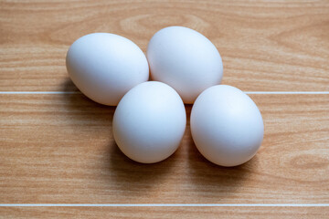 White chicken eggs on a wooden background. These eggs are naturally reared country chicken eggs in the village home of Bangladesh.