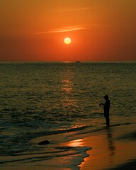 A fisherman in the Delaware Bay at sunset, Cape May, New Jersey