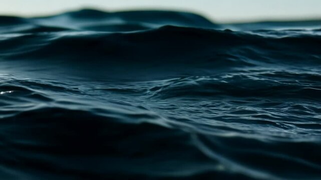 Black ocean close up view, Slow motion shot of water dripping and flowing, dark water waves in detail. 4K Video 