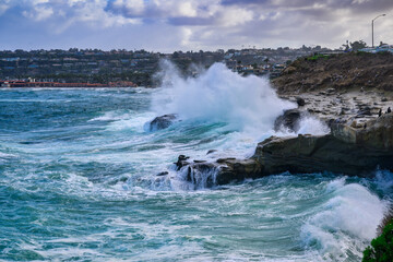 2024-01-11 BIG WAVES CRASHING ON THE ROCKS IN THE LA JOLLA COVE DURING ROUGH SEAS NEAR SAN DIEGO CALIFORNIA