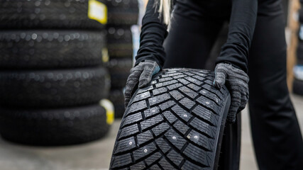 Mechanic keeps new studded car tires in garage.  © Михаил Решетников