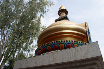 top of colorful buddha "stupa" or dome shaped buddhist relic struture in  photographic angle at "karma temple", bodh gaya, bihar, india