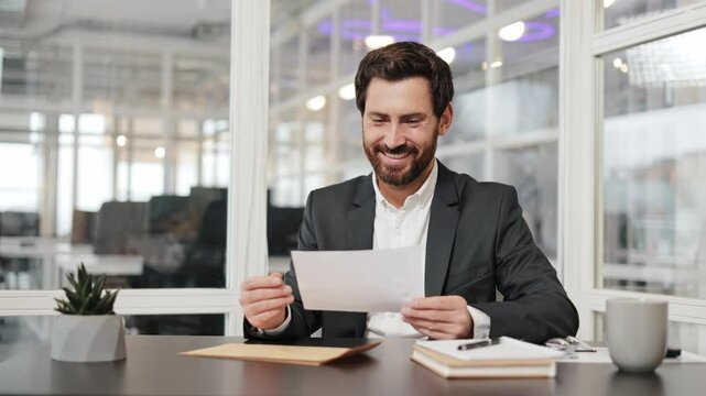 Successful businessman manager in office open paper envelope read letter good news received bank loan approval profitable proposition happy man get promotion career advance great opportunity