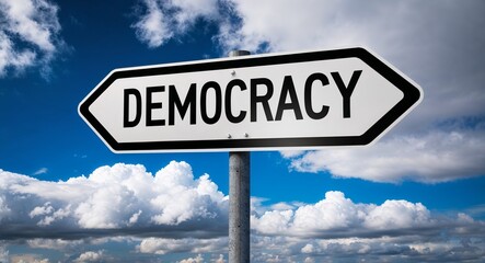 Fototapeta premium democracy text on road sign with clouds and sky background