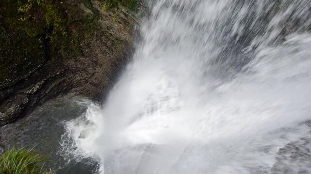 the splendid spectacle of nature in a waterfall of a small mountain stream
