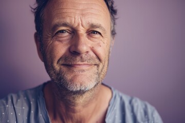 Obraz premium Middle-Aged Man with Confident Smile on Lavender Background for Portrait and Design