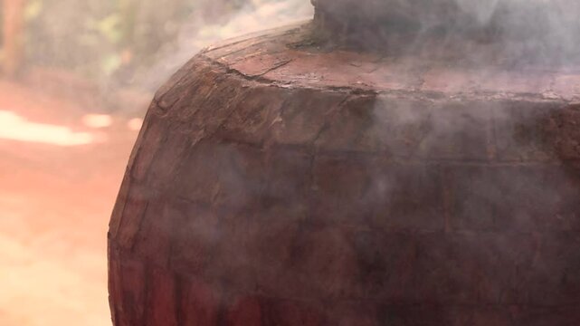 A stone brick tandoor oven in a luxurious restaurant for roasting meat and fish in the tandoori style.