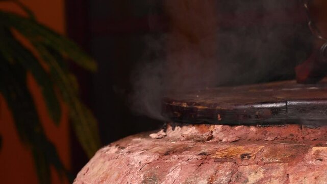 A stone brick tandoor oven in a luxurious restaurant for roasting meat and fish in the tandoori style.
