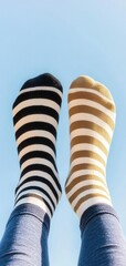 Two feet in striped socks, playfully kicking up in the air, symbolizing carefree fun and relaxation, International Sock Day Concept