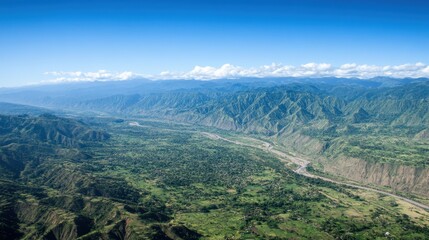 Obraz premium A breathtaking aerial view of a mountain range with valleys, forests, and rivers, showcasing nature's beauty.
