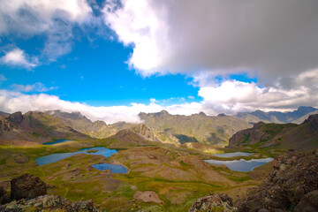 Lakes and mountains with partly cloudy sky. Nature or environment concept photo