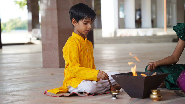 A Hindu family gathered around a sacred fire, performing a Yagya during a festival celebration