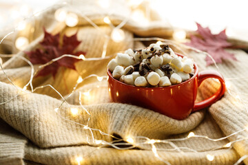 Cocoa and marshmallows in red ceramic cup
