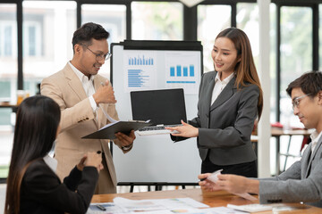 Asian Business Group Chat about graph work Present in meetings, in the office.