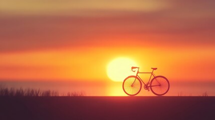 Fototapeta premium A silhouette of a bicycle on a road overlooking a sunset.