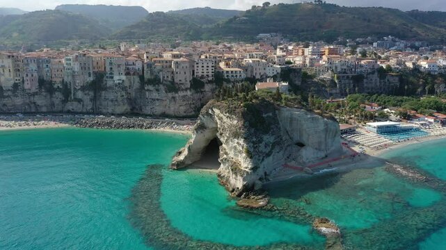 Aerial view of cliffs, historic tourist center of the city, monastery Santuario di Santa Maria dell'Isola di Tropea sunny summer day in Calabria region, Italy