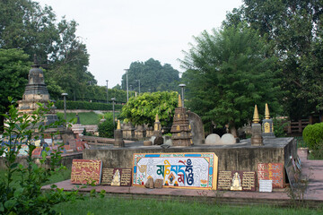 decorated 'stupa' or conical buddhist relic structure with chants written in pali and sanskrit on metal tablets inside temple premises of "mahabodhi temple", bodh gaya, india
