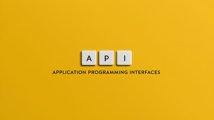 Obraz premium API, application programming interface on a yellow background with three wooden blocks text API