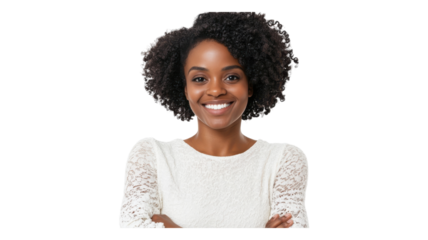 Smiling woman with curly hair wearing a light sweater poses confidently, showcasing her joy and positivity against a clean background.