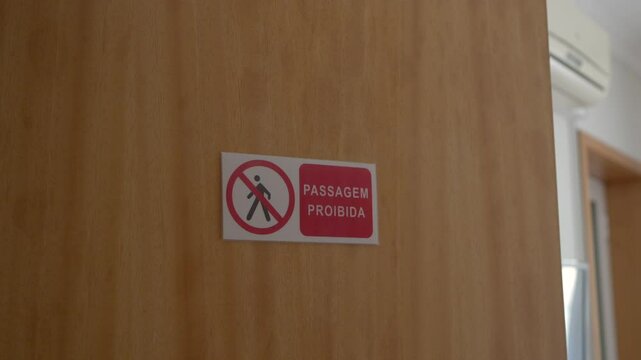 "Passagem Proibida" sign on a wooden door indicating no entry