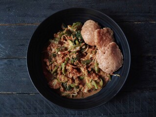 Gado gado on the wooden table. Gado-gado is a dish consisting of vegetables seasoned with peanut sauce and so on.