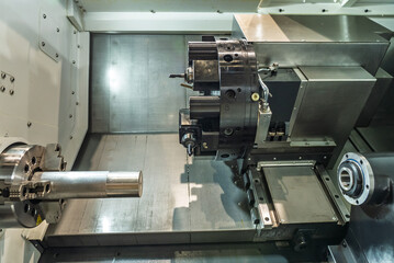 Inside view of a cnc machine. CNC lathe interior.Cnc machine. The CNC lathe machine or Turning machine. Turning numerical control machine with tools and chuck.