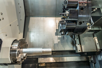 Inside view of a cnc machine. CNC lathe interior.Cnc machine. The CNC lathe machine or Turning machine. Turning numerical control machine with tools and chuck.