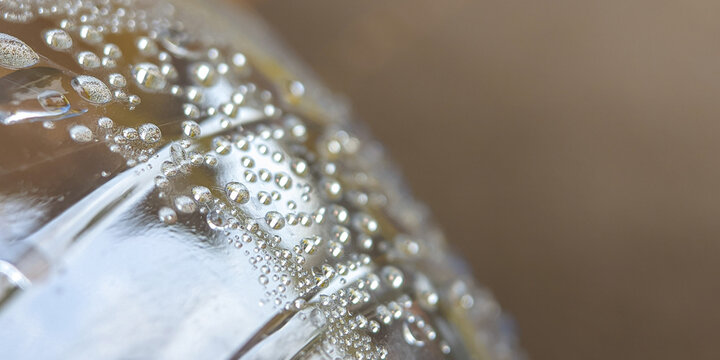 Close up of a plastic bottle filled with cold water with condensation drops. food and drink background.