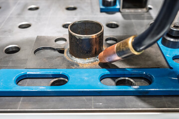 Robot welding steel. Industrial welding robot and working with metal parts. Robot welds steel. Welding head. Welding robot. CNC welding. Robotization and automation of the welding process.