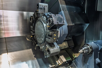 Inside view of a cnc machine. CNC lathe interior.Cnc machine. The CNC lathe machine or Turning machine. Turning numerical control machine with tools and chuck.