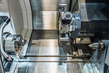 Inside view of a cnc machine. CNC lathe interior.Cnc machine. The CNC lathe machine or Turning machine. Turning numerical control machine with tools and chuck.