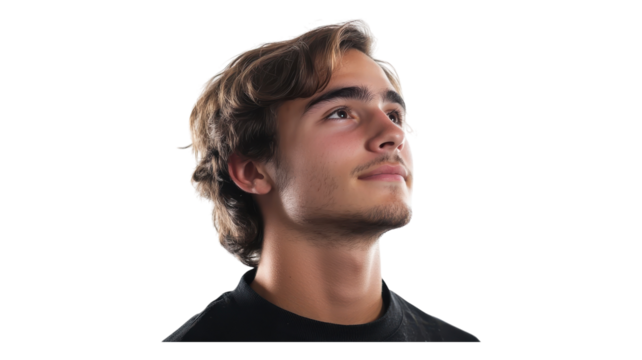 Young man with wavy hair gazing upward, expressing contemplation against a transparent backdrop in a relaxed setting.
