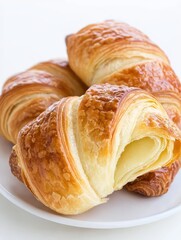 Crisp round croissants: golden flaky shell with a crumbly, airy interior, perfect for a delightful breakfast treat.
