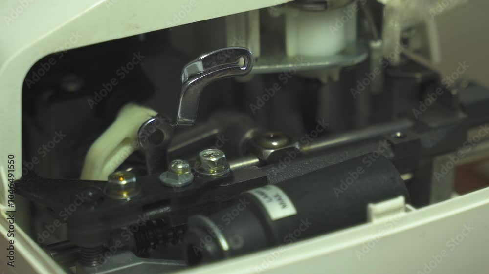 Poster a woman carefully applies lubricant to the intricate components of a sewing machine, ensuring each p