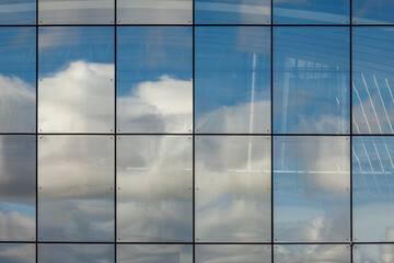 Background image - facade of a modern building made of mirror panels