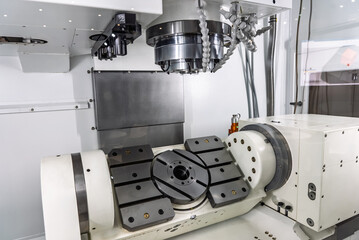 Five axis milling machining center. Interior of a 5 axis milling machine. Milling machine with a rotary table. Multi axis CNC machine.