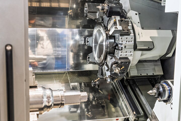 Fototapeta premium Inside view of a cnc machine. CNC lathe interior.Cnc machine. The CNC lathe machine or Turning machine. Turning numerical control machine with tools and chuck.