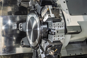 Inside view of a cnc machine. CNC lathe interior.Cnc machine. The CNC lathe machine or Turning machine. Turning numerical control machine with tools and chuck.