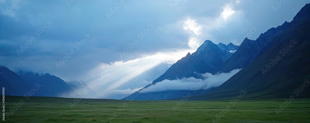 Poster mountain landscape with dramatic clouds and sunlight filtering through.