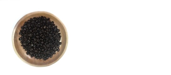 dish of roasted coffee beans on brown wood plate  isolated on white background with copy space