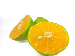 Lemon and slice isolated on white background. orange peel is green
