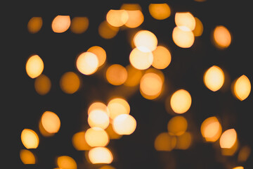 Bright yellow, gold lights, bokeh on black background