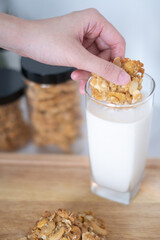 Close-up hand holding homemade baking cookies snack dipping into glass milk drink perfect for morning delicious tasty breakfast full of nutrition freshness healthy eating lifestyle meal concepts